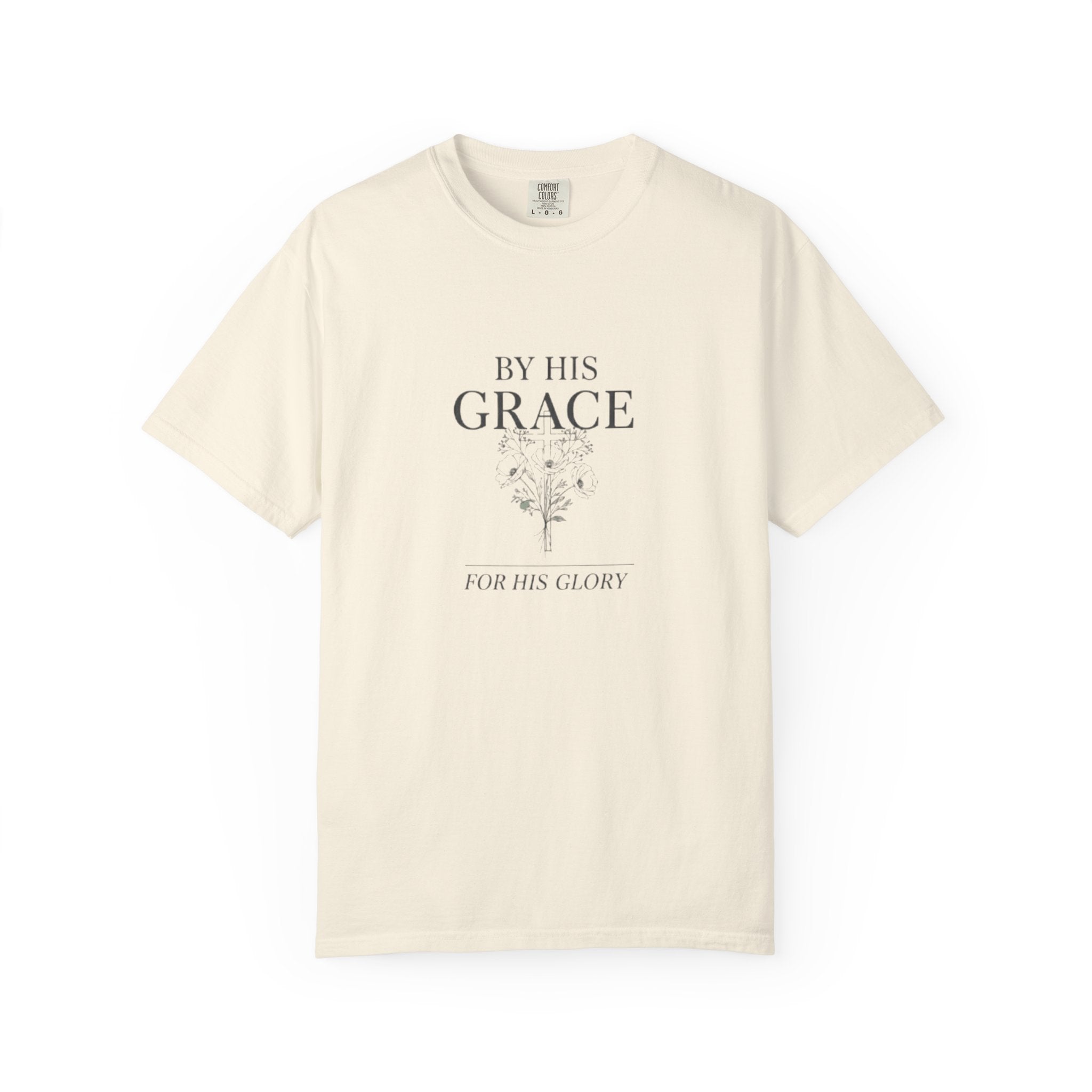 Beige t-shirt with text 'By His Grace, For His Glory' on a white background