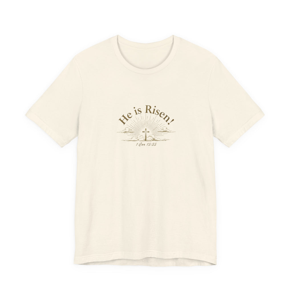 Beige t-shirt with 'He is Risen!' text and cross design on a white background