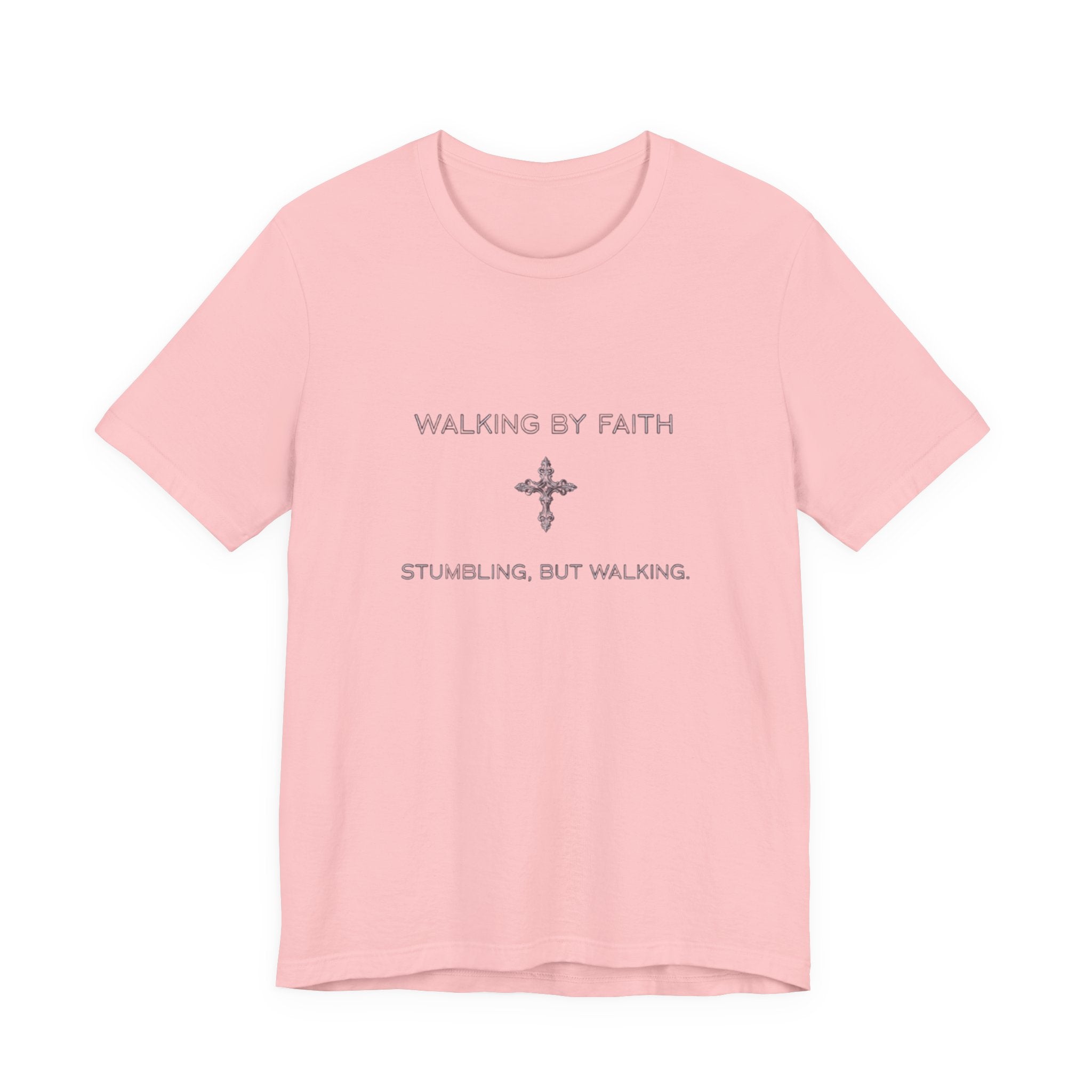 Pink t-shirt with text 'Walking by Faith, Stumbling, but Walking' on a white background