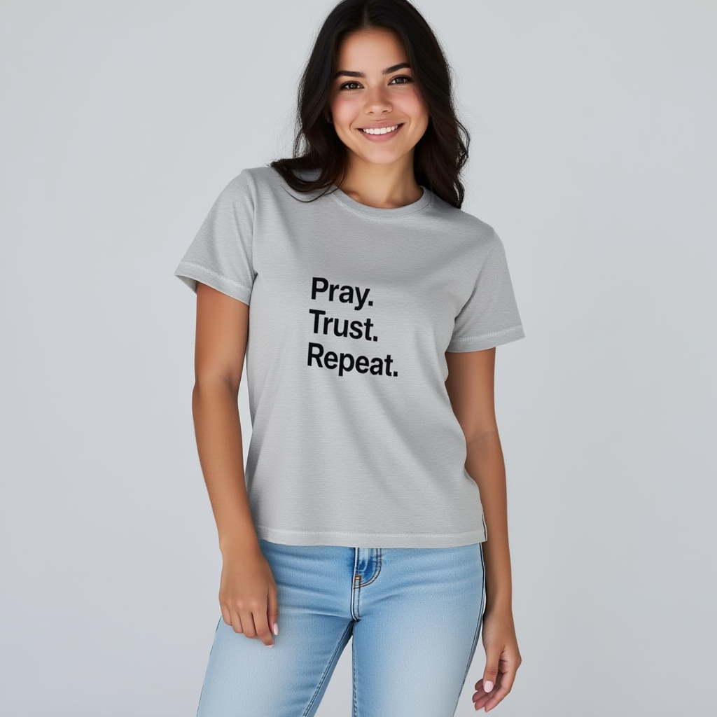 Person wearing a gray t-shirt with 'Pray. Trust. Repeat.' text on a plain background