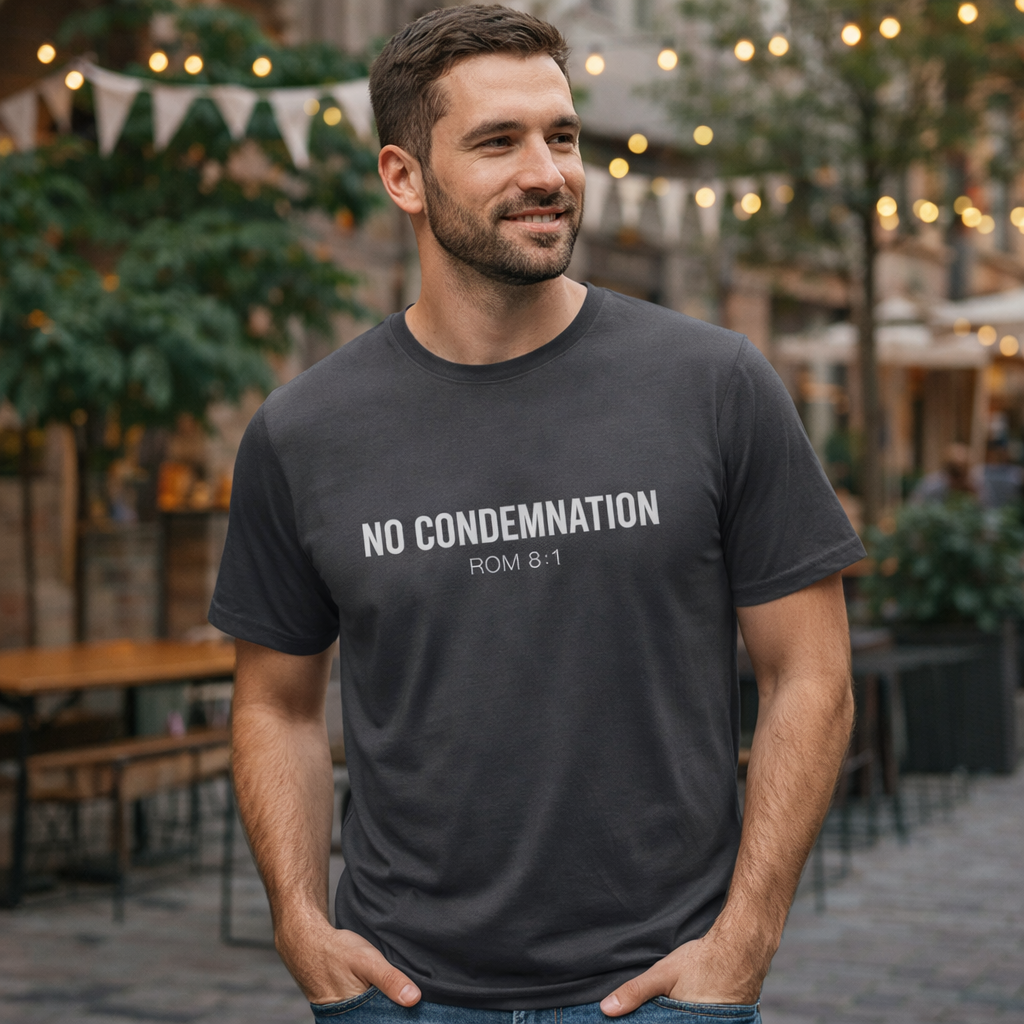 Man wearing a black t-shirt with 'NO CONDEMNATION ROM 8:1' text outdoors.