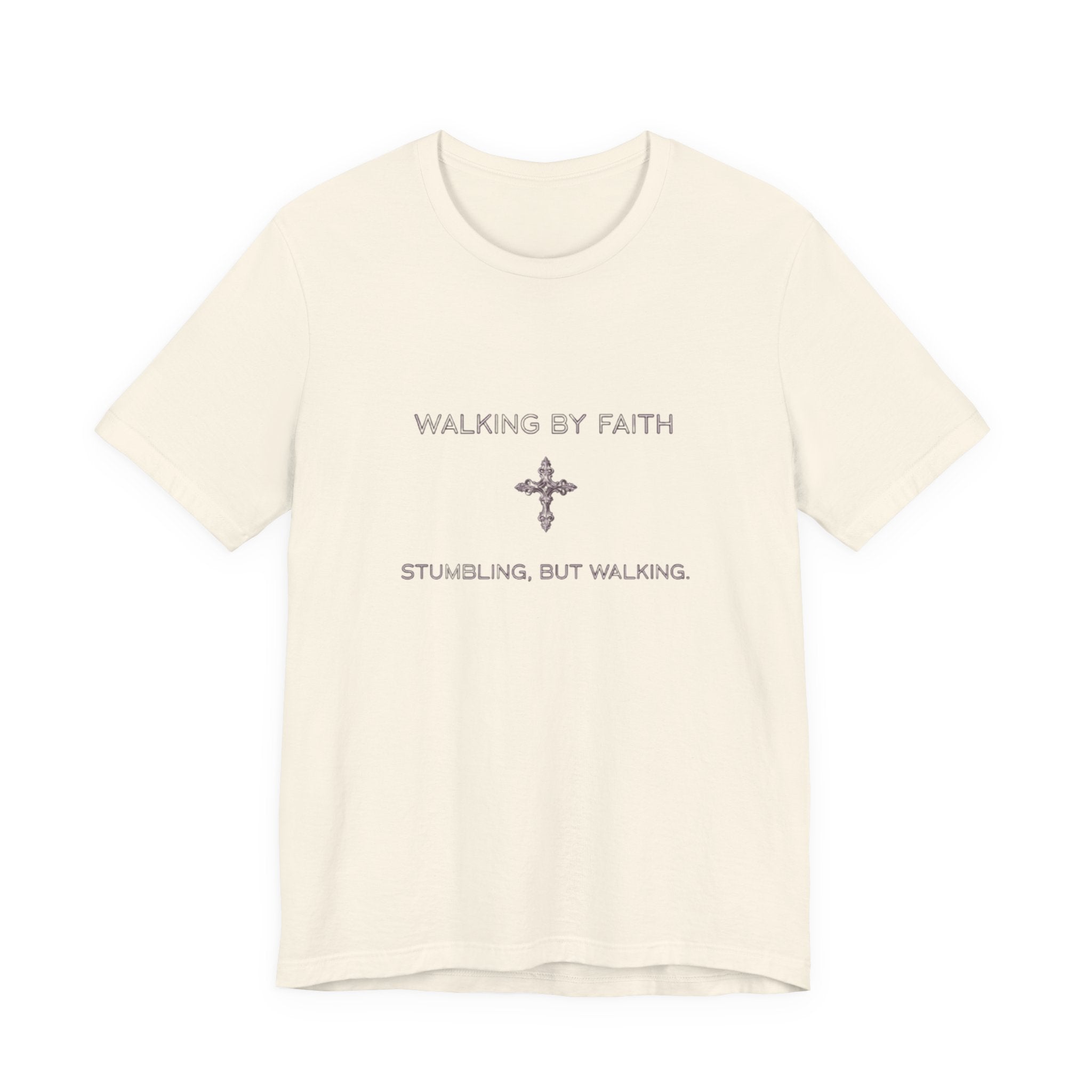 Beige t-shirt with text 'Walking by Faith, Stumbling, But Walking' on a white background
