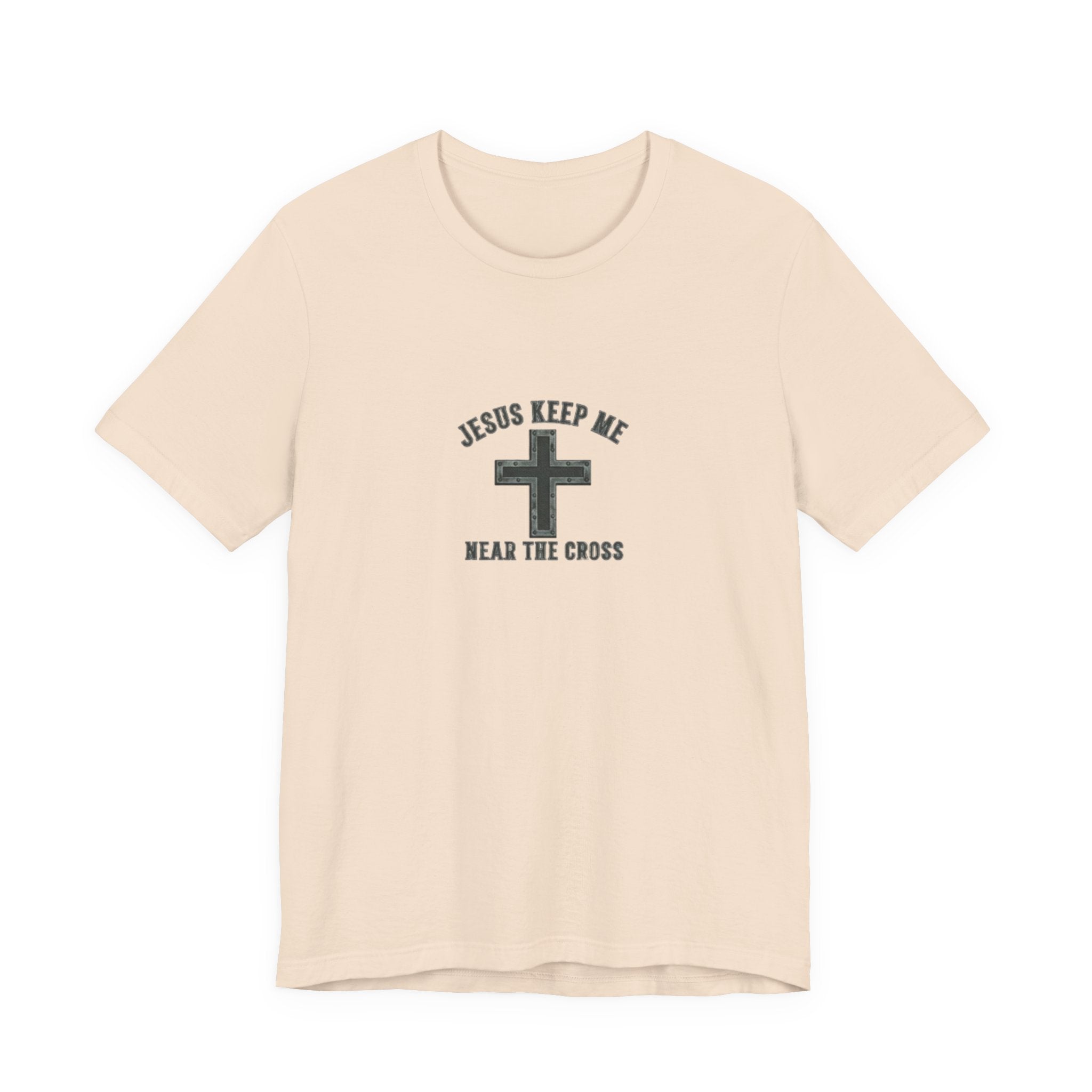 Beige t-shirt with a cross graphic and text on a white background