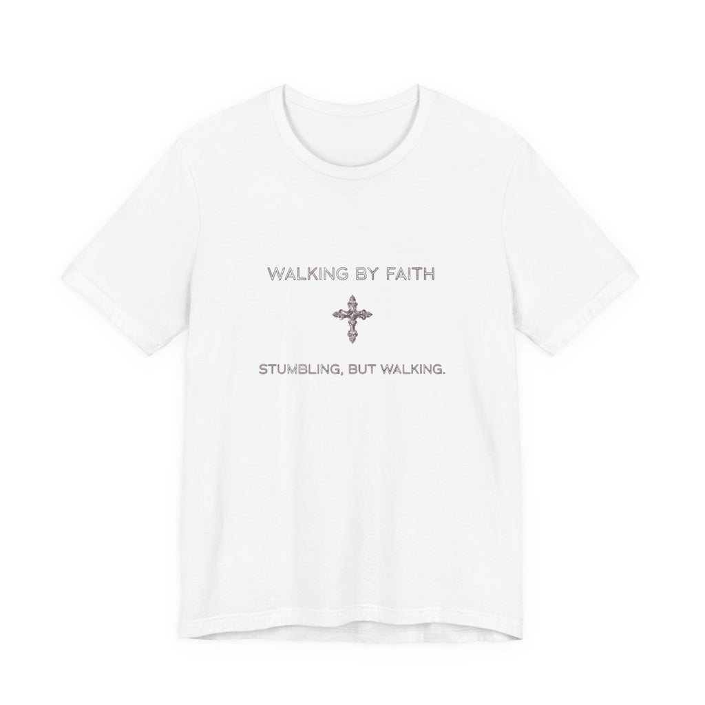 White t-shirt with 'Walking by Faith, Stumbling, But Walking' text and cross symbol on a white background