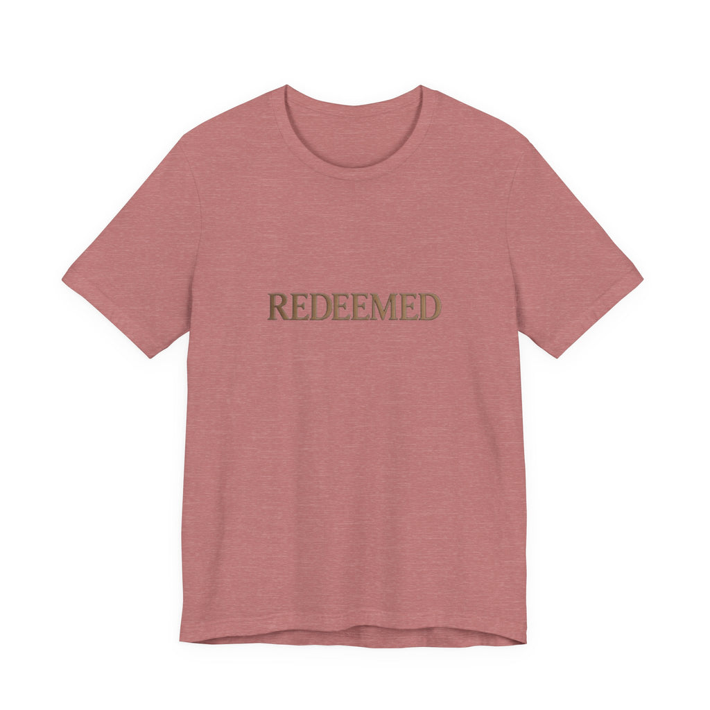 Pink t-shirt with 'REDEEMED' text on a white background