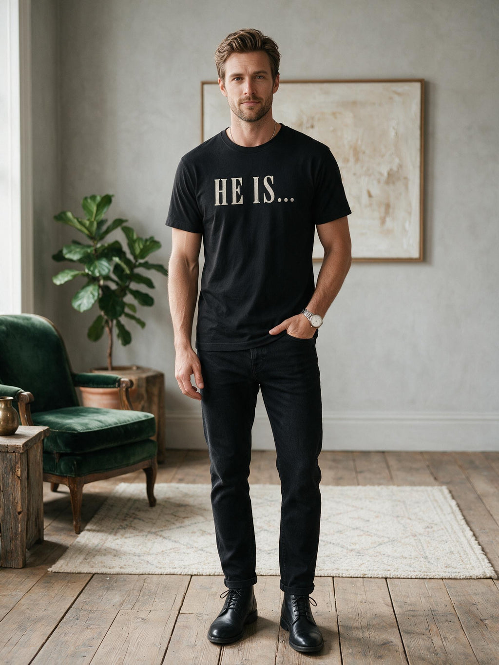A man wearing a black crewneck t-shirt with 'HE IS.