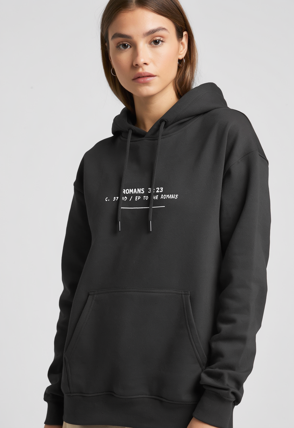 Person wearing a black hoodie with text on a light gray background