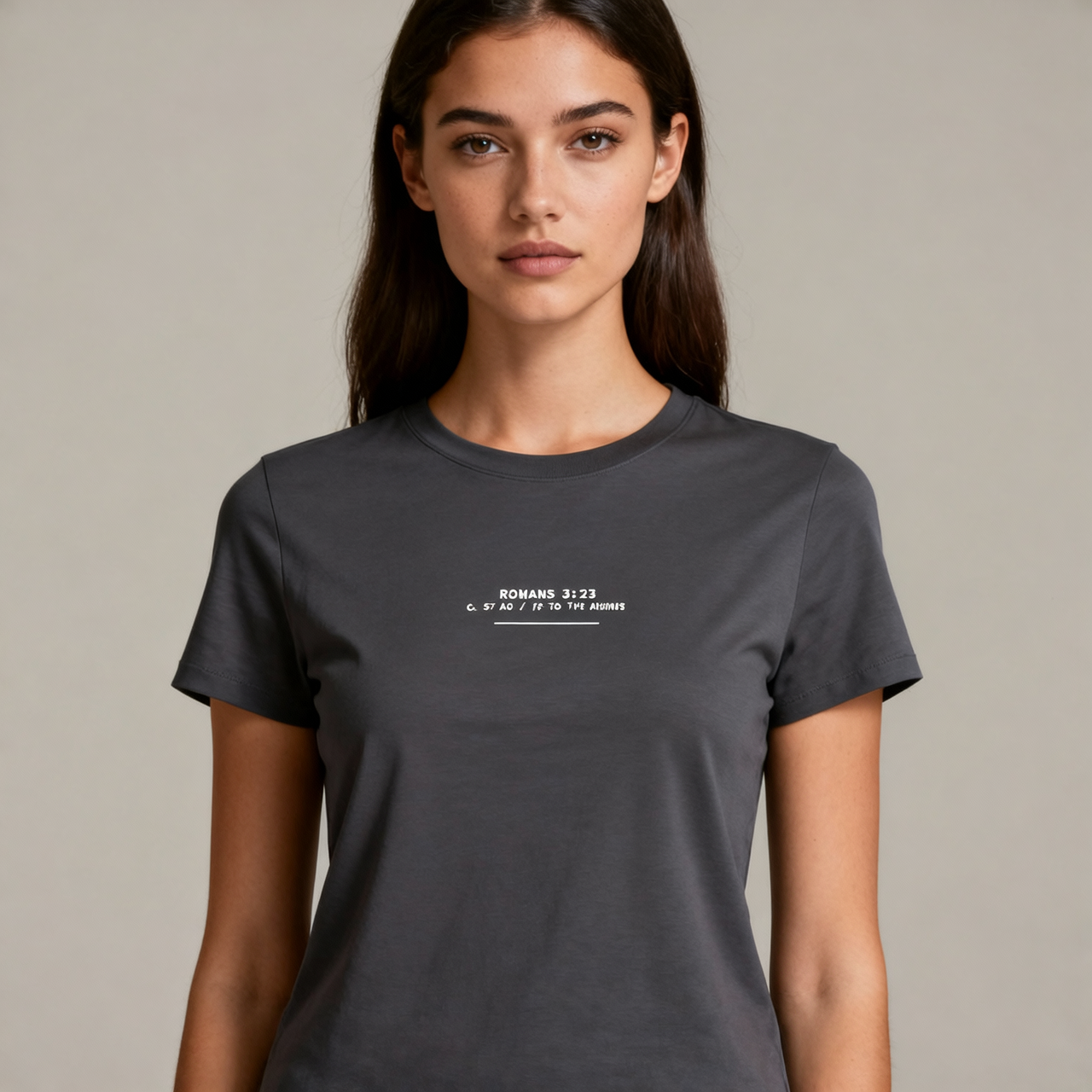 Woman wearing a dark gray t-shirt with text on a plain background