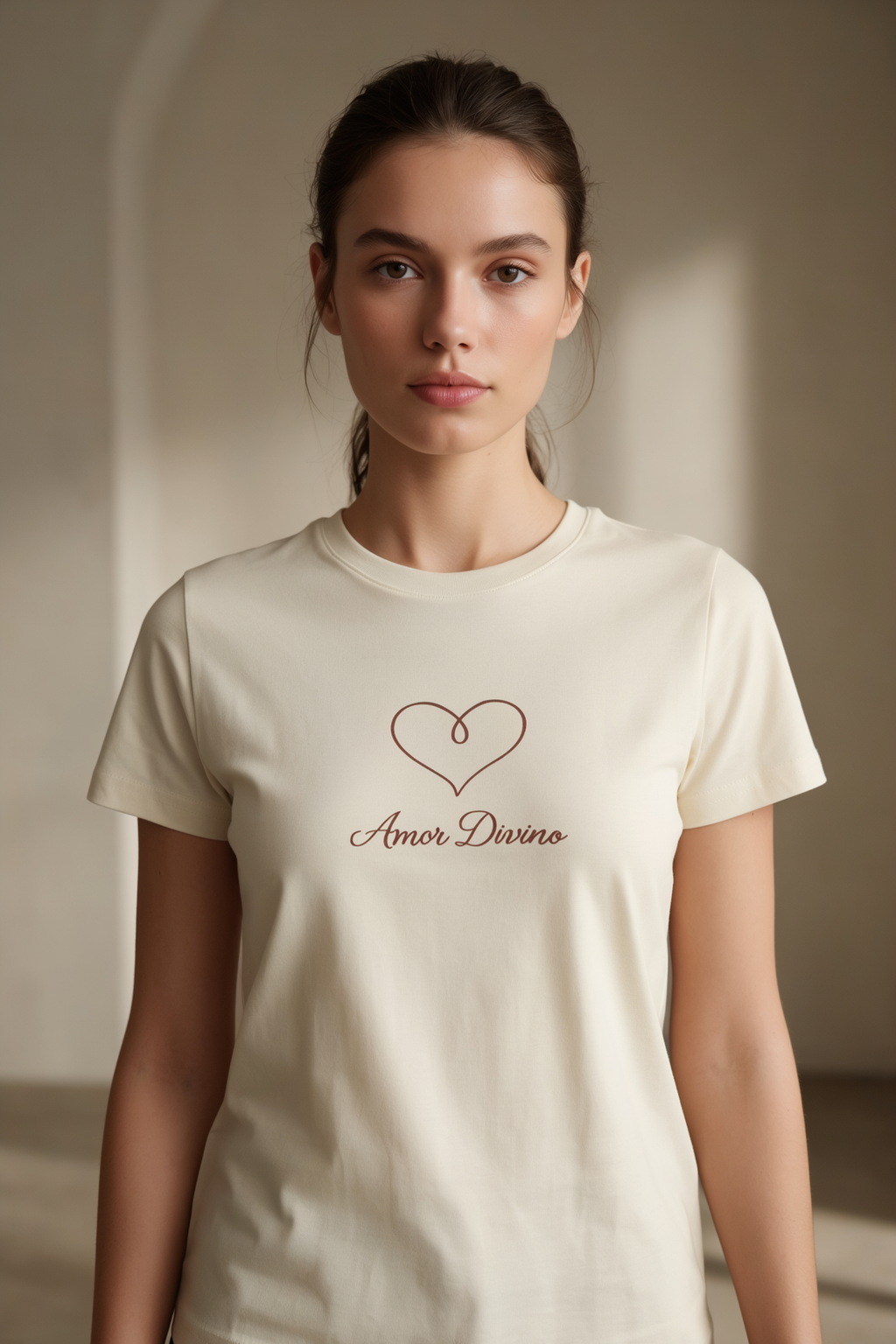 woman wearing butter shirt with heart and text that says amor divino.