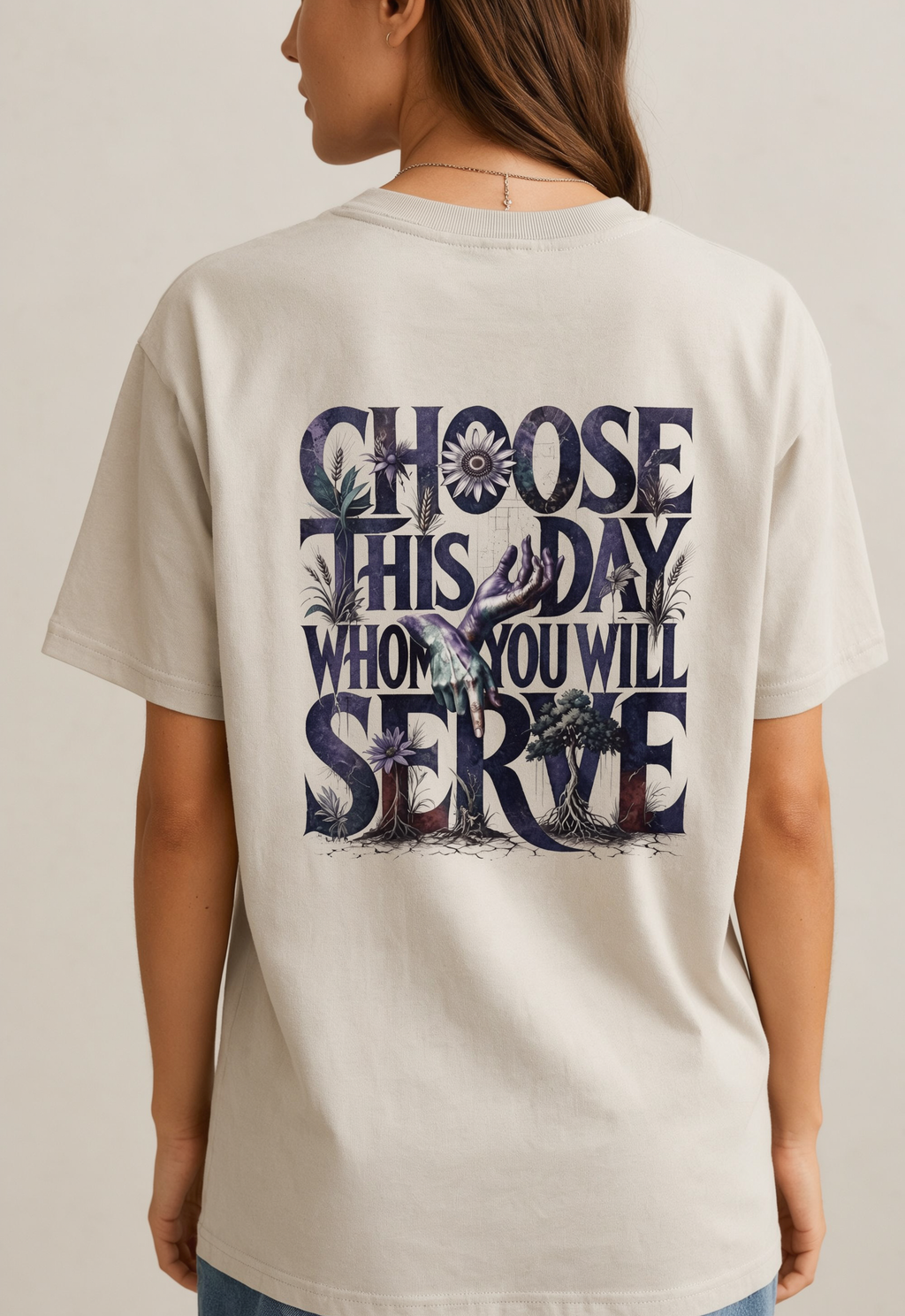 Person wearing a beige t-shirt with a motivational quote on the back against a plain background
