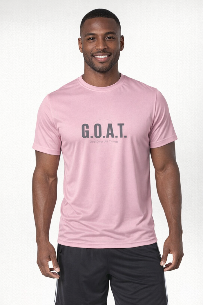 A man wearing a light pink athletic t-shirt with 'G.O.A.T.