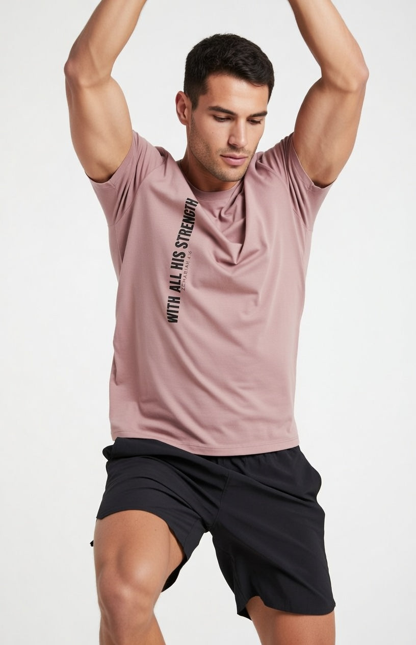 Male model wearing With All His Strength Faded T-Shirt in Faded Rose — editorial style front view, Colossians 1:29 design, garment-dyed Christian tee by 4HG