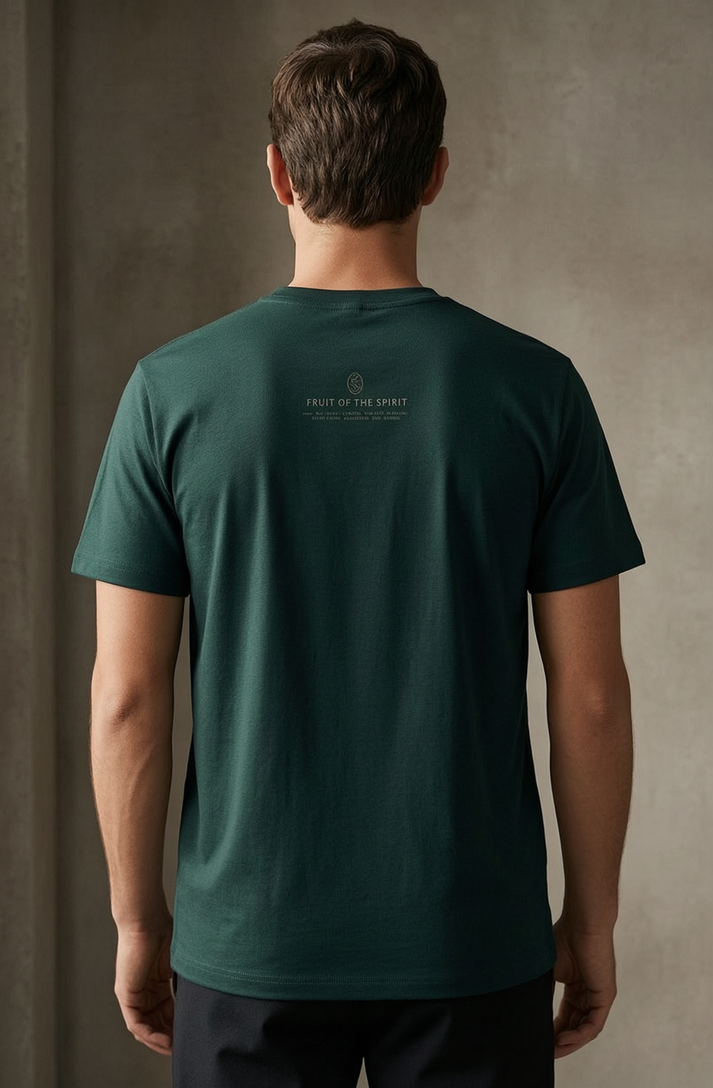 man wearing pine green t shirt with Fruit of the Spirit Logo on back.