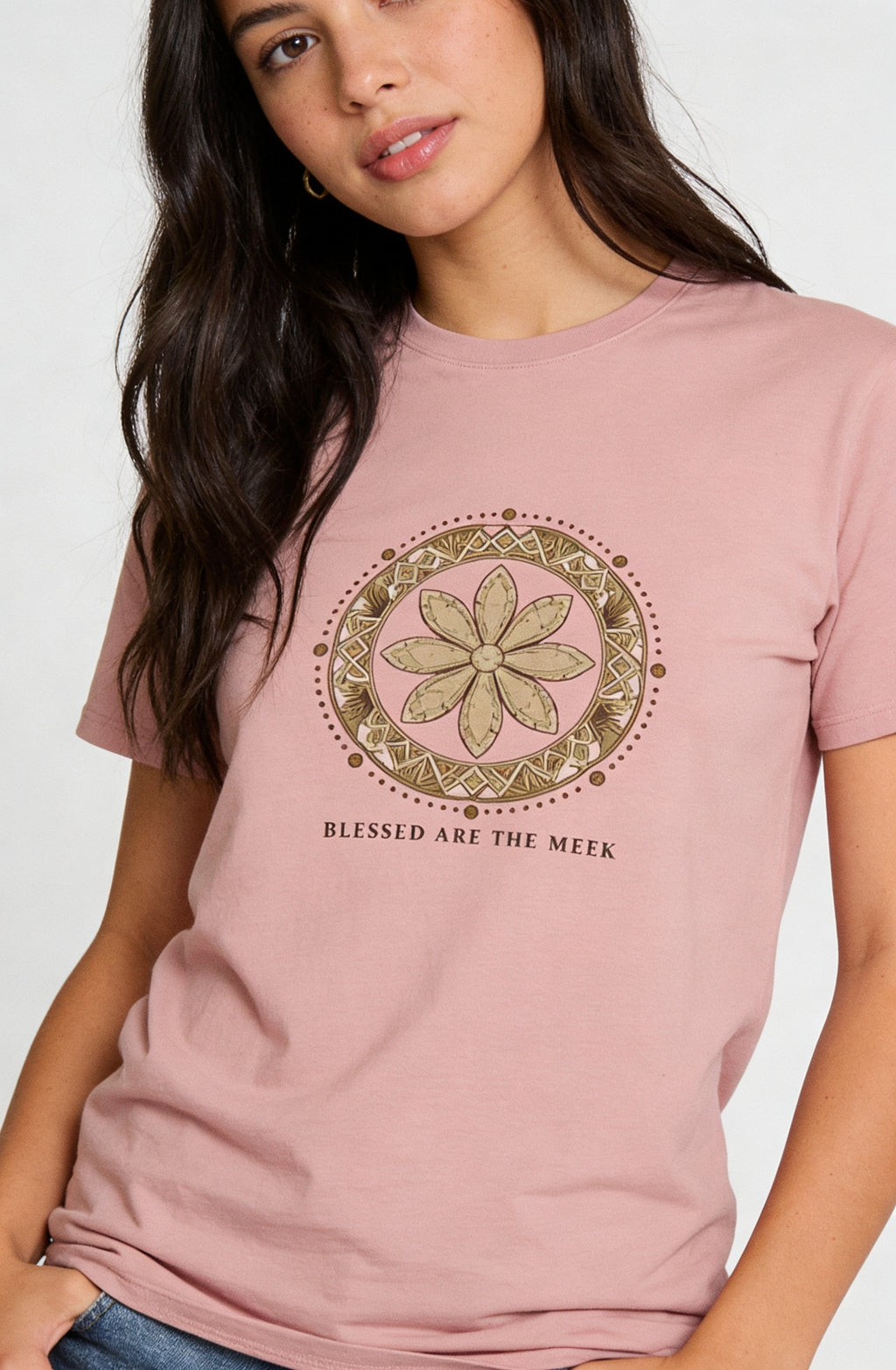 Woman wearing a pink t-shirt with a green mandala design and text on a white background