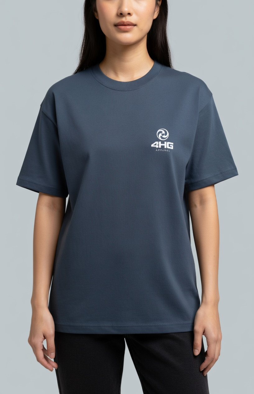A woman wearing a slate blue crewneck t-shirt with a small white 4HG logo on the left chest, set against a solid gray studio background.