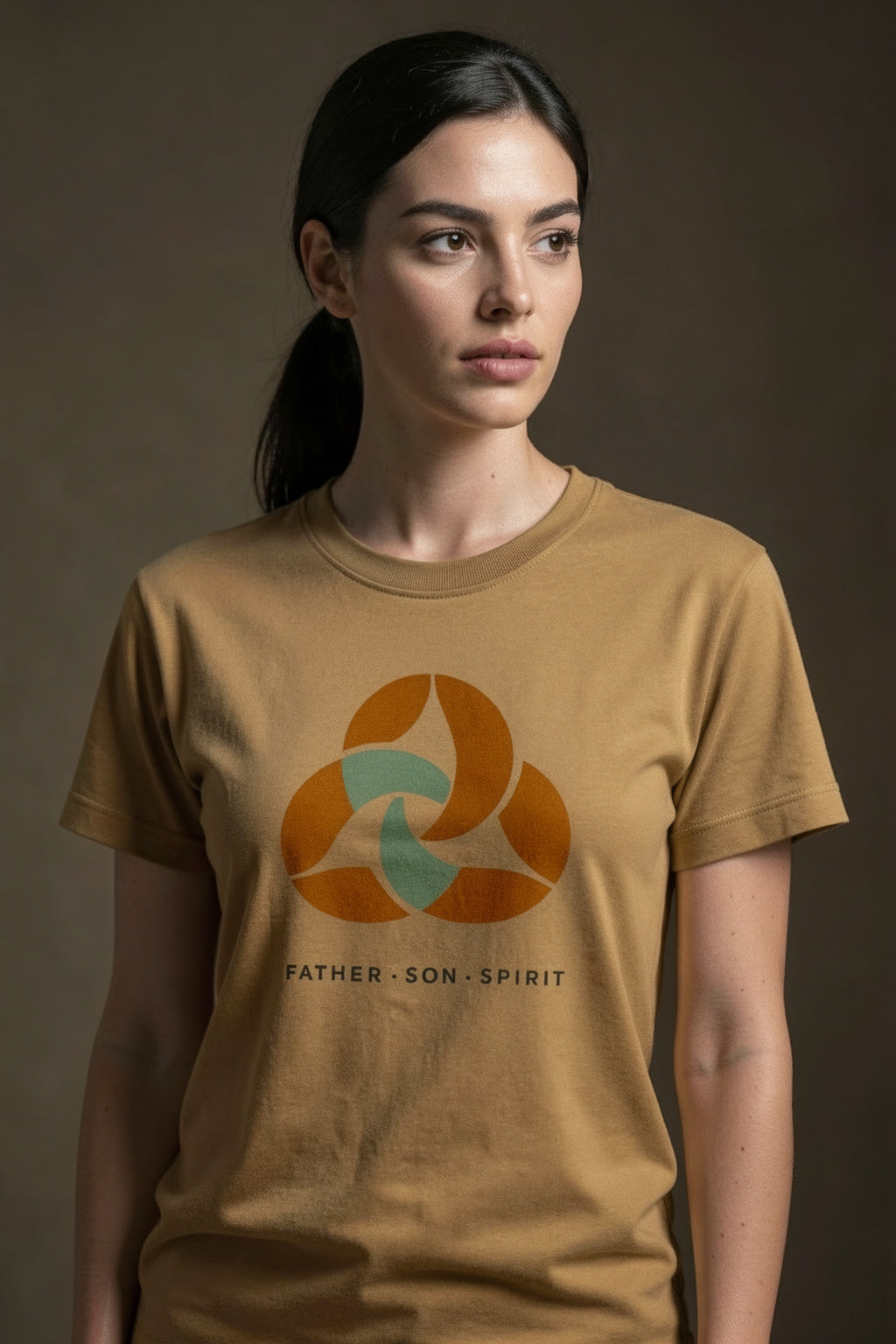 Female model wearing Trinity Men's Staple Faded Tee in Faded Mustard — editorial style front view, 2 Corinthians 13:14 Trinity design, garment-dyed Christian tee by 4HG