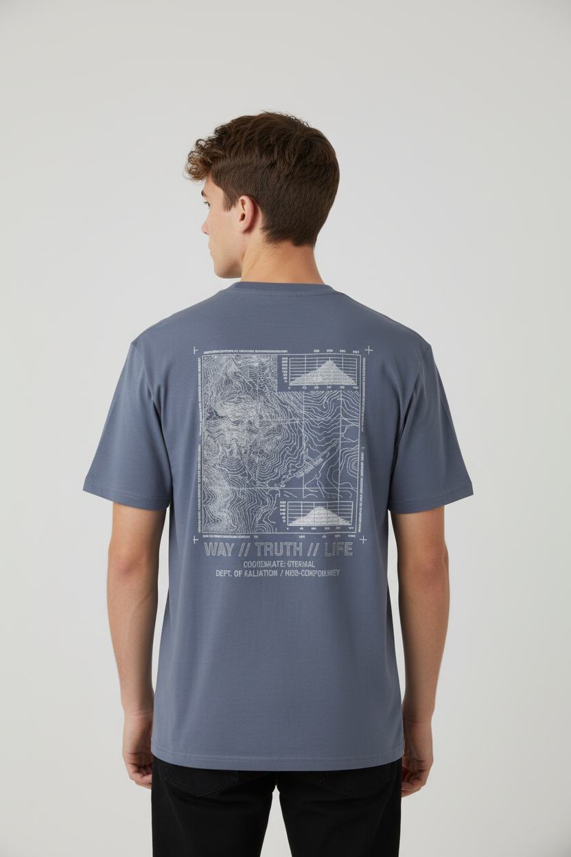 A man wearing a slate blue t-shirt with a white graphic print on the back, shown from behind against a light gray studio background.