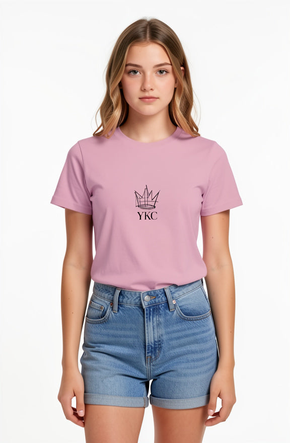 Woman wearing a pink t-shirt with a logo and text, standing against a white background